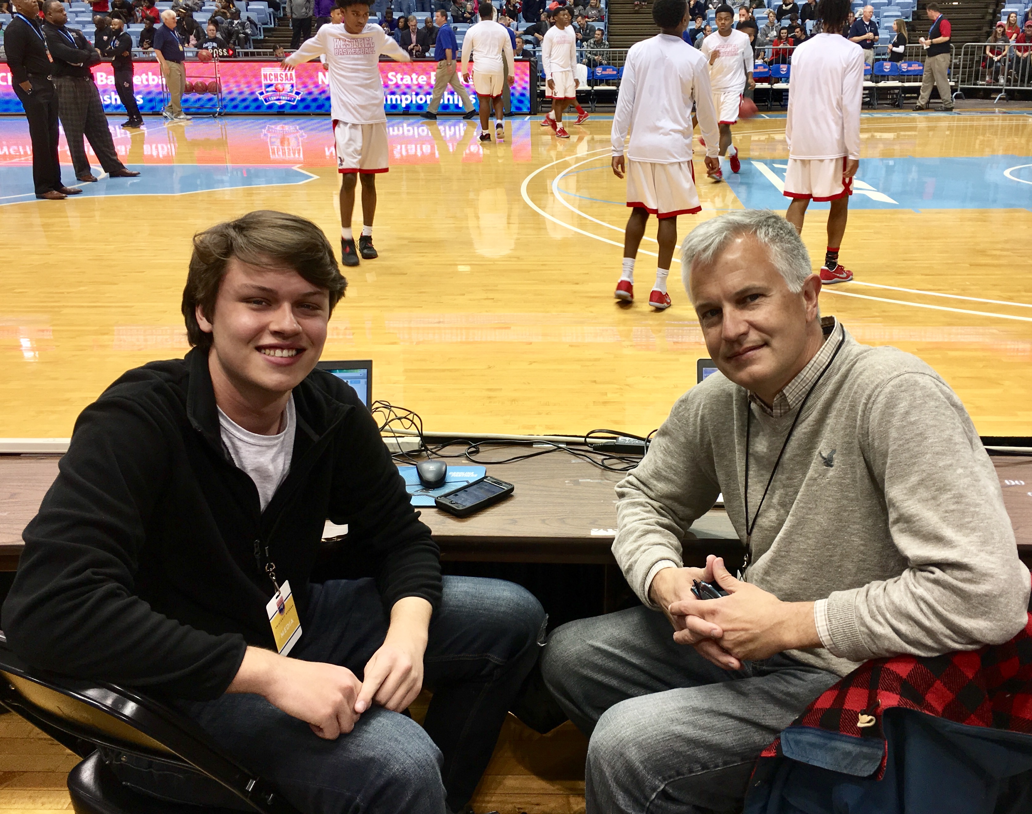 Chapel and Scott Fowler covering a 2017 high school championship game at the Smith Center 