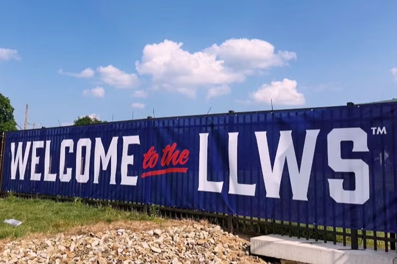 a large sign that reads "Welcome to the LLWS" hangs from a gate