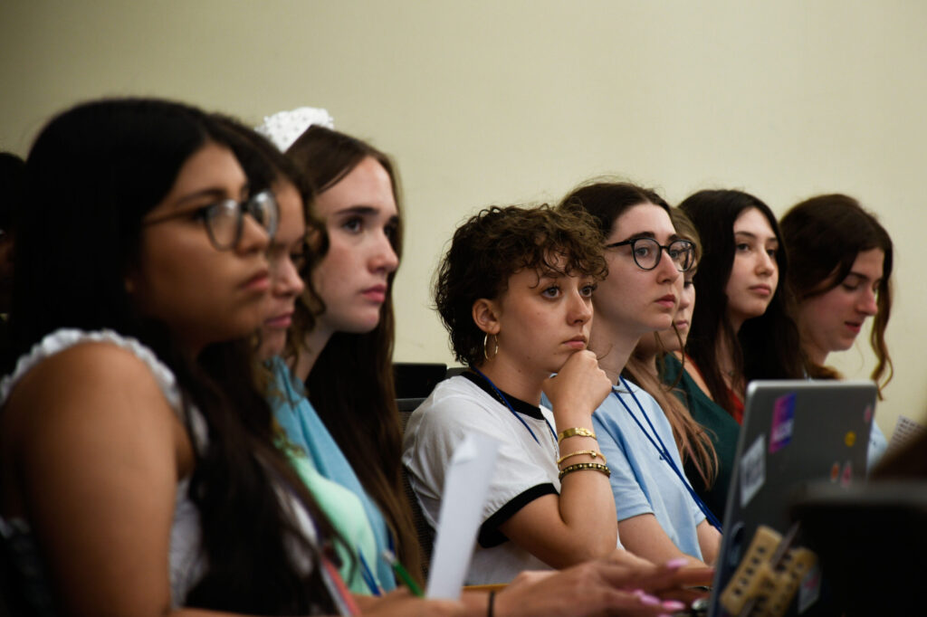 close up of 7 high school students paying attention to something out of the frame