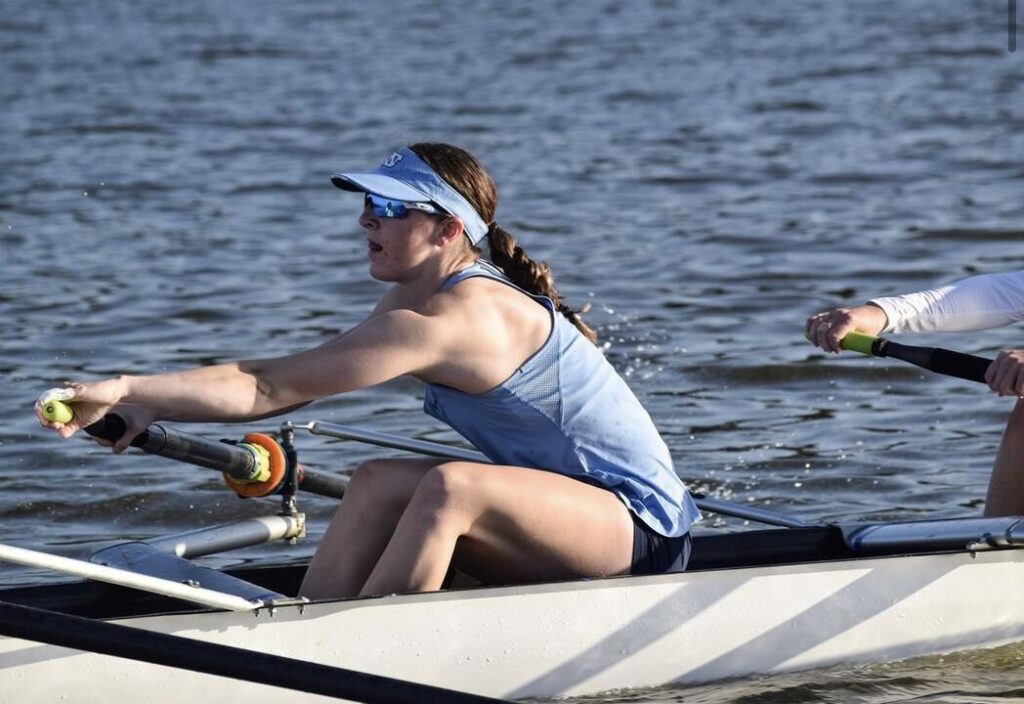 a girl rows in a boat
