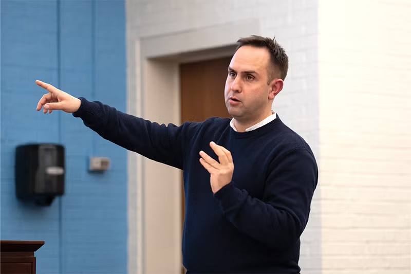 a man points to the left