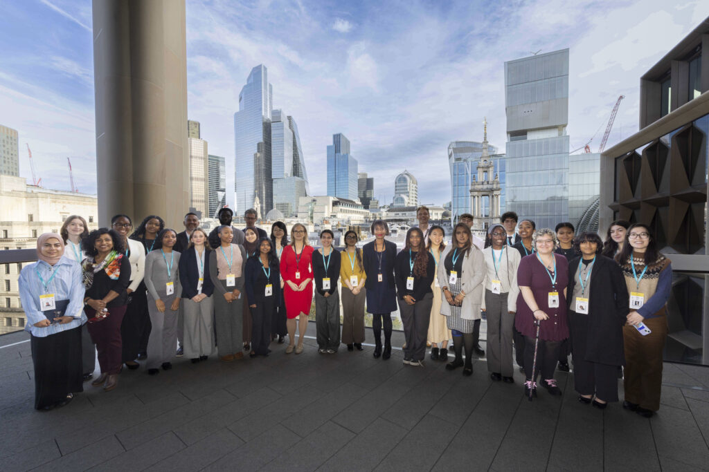 The 2024 Bloomberg cohort poses on a balcony overlooking the skyline of London
