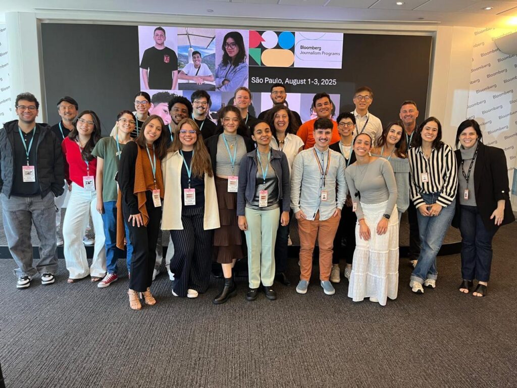 a group of students and instructors stand in front of a sign that reads "Bloomberg Journalism Programs, Sao Paulo 2025"