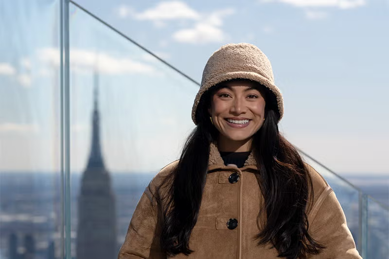 Jenny Chiu smiles with the cityscape in the background.