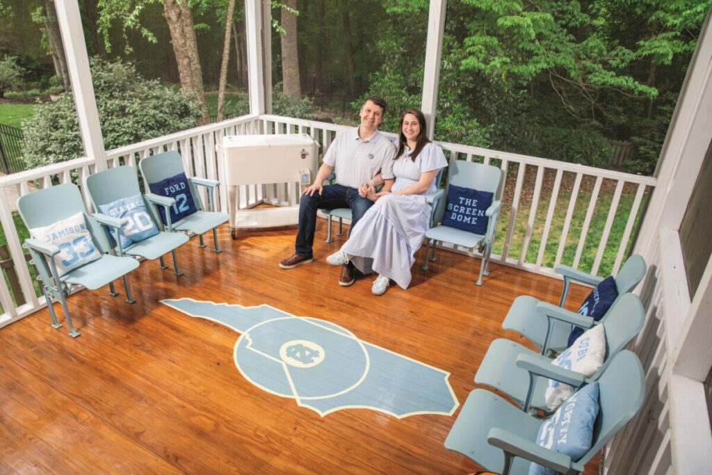Taylor Mathis and Sara Mathis sit in their UNC-themed porch at their house.