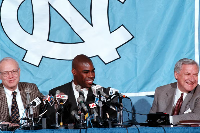 Antawn Jamison sits behind microphones at a press conference.